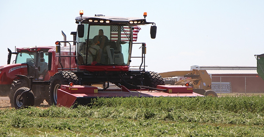 The Hesston by Massey Ferguson self-propelled windrowers in field at HHD The Hesston by Massey Ferguson self-propelled windrowers in field at HHD