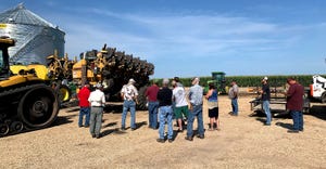 Farmers are examining a strip-till machine during a field day