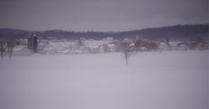 snow blowing across farmland 