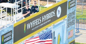 2 men on Wyffels Hybrids stage at Farm Progress Show