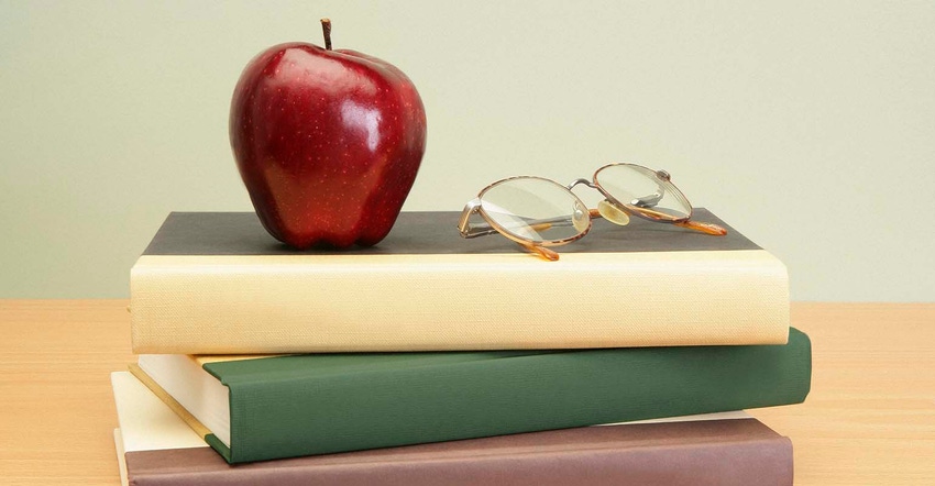 textbooks with apple and glasses 