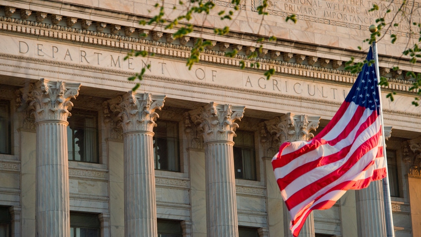 American flag flying in front of the Department of Agriculture building American flag flying in front of the Department of Agriculture building
