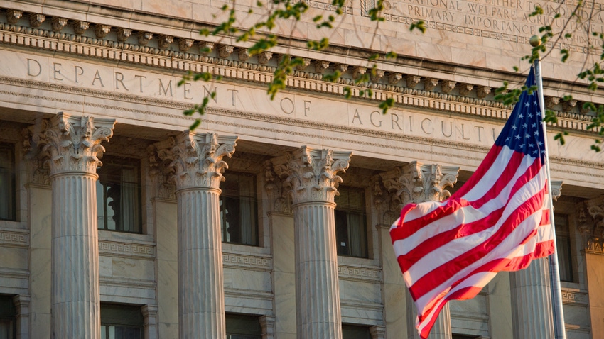 American flag flying in front of the Department of Agriculture building