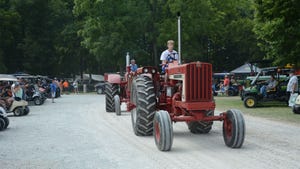 A parade of vintage Farmall tractors