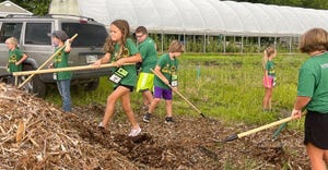 Children at The Field to Fork program shoveling mulch