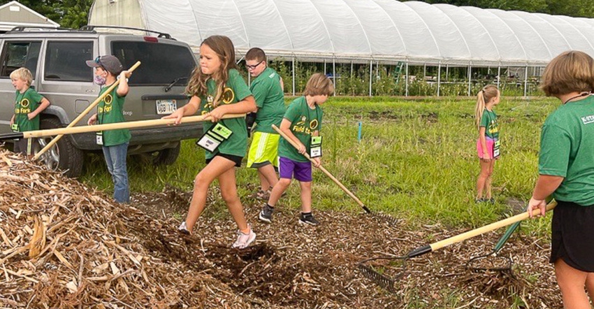 Children at The Field to Fork program shoveling mulch Children at The Field to Fork program shoveling mulch