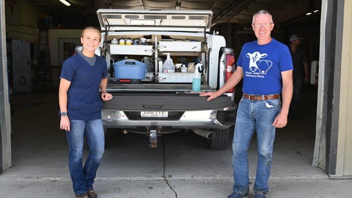 woman and man at pickup next to tailgate 