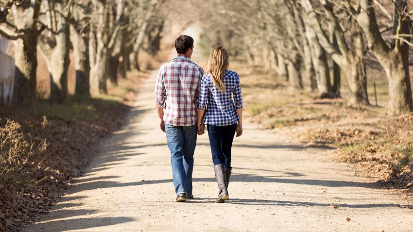 Young couple walking on country lane