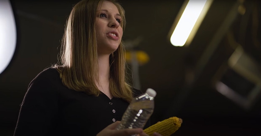 Alexis Hartman holding bottle of water and ear of corn on Super Bowl commercial