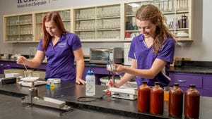 2 young women conducting experiments in lab