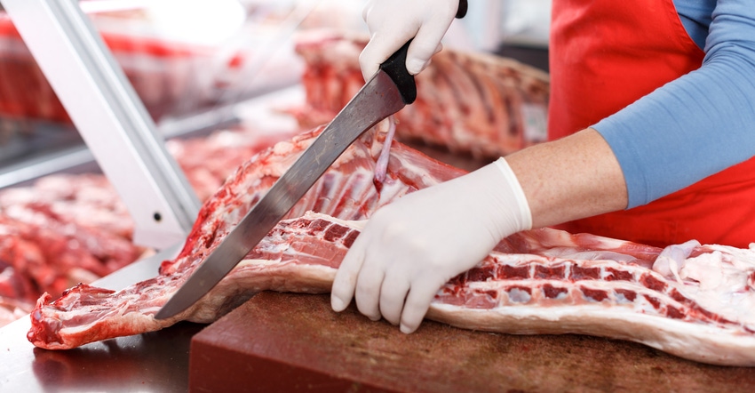 butcher cutting pork