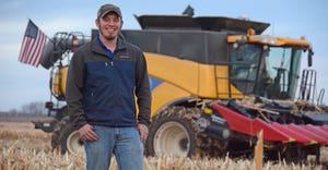 Ryan Atherton standing in front of combine