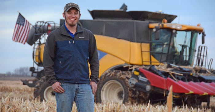 Ryan Atherton standing in front of combine