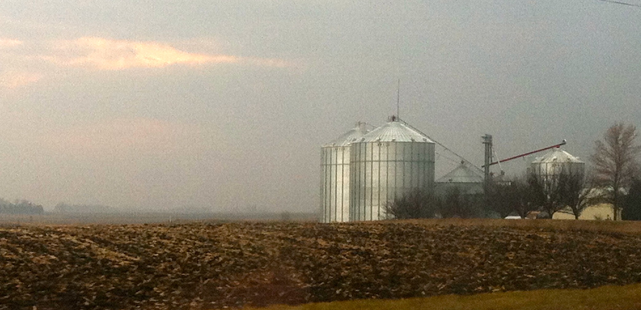 Tips For Managing Corn Soybeans In Grain Bins   Grain Bins Fall Clouds 