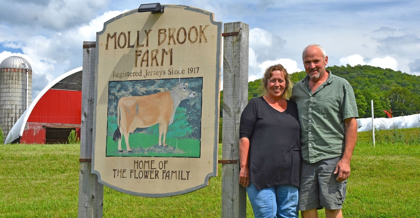 Myles and Rhonda Goodrich stand by Molly Brook Farm sign