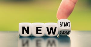 Hand turns a dice and changes the expression "new year" to "new start". New Year's Resolutions