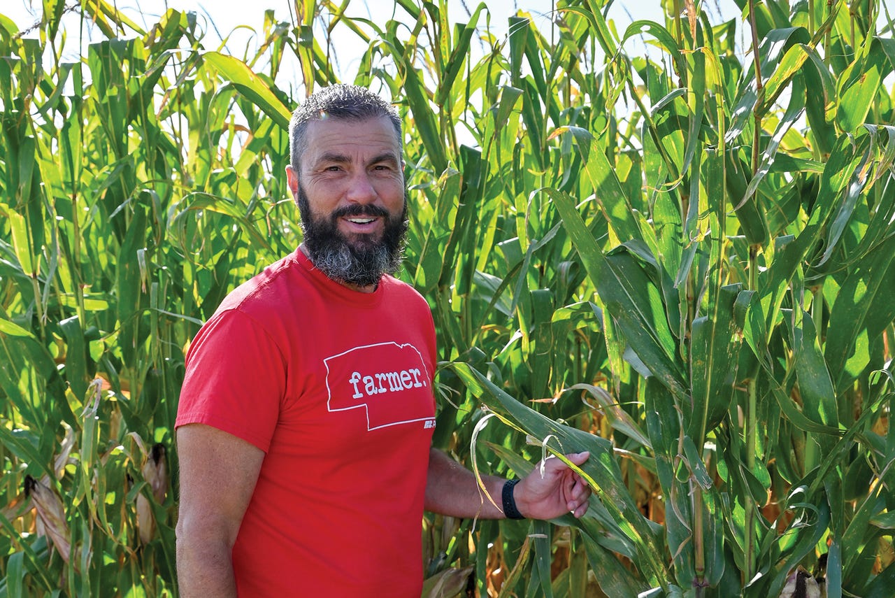 Farmer Brandon Hunnicutt by corn field