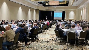 Ballroom full of seated attendees at a conference