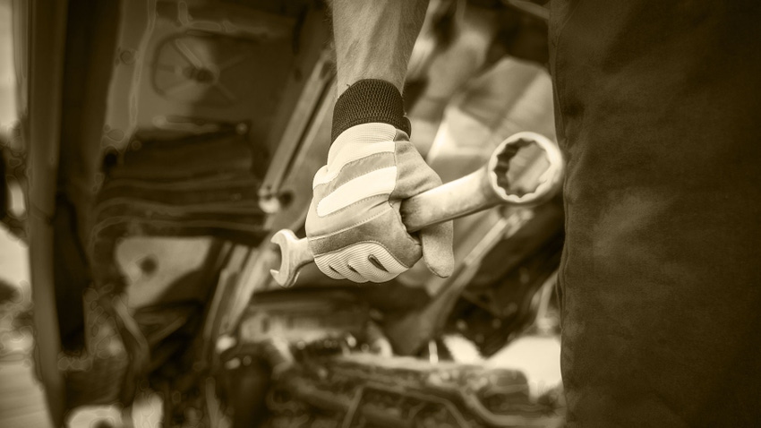 Mechanic with large wrench in hand