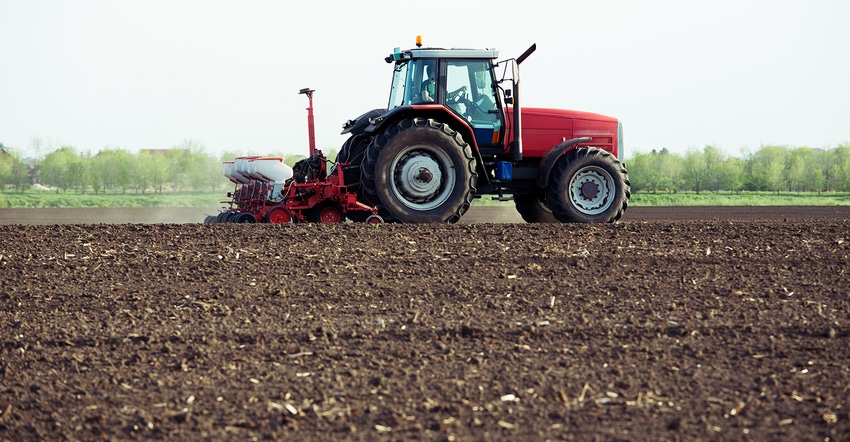 tractor and planter in field