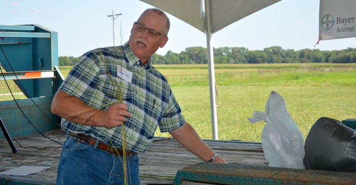 Lyon County Extension Agriculture Agent Brian Rees holds invasive species yellow bluestem and caucasian bluestem
