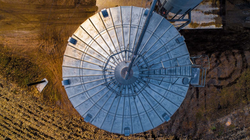 Aerial view looking at the top of a Midwest grain bin at dusk.