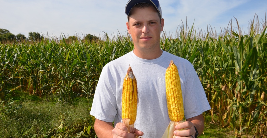 Nathan Bush holding two ears of corn