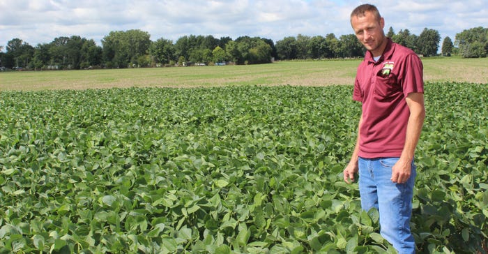 Josh Kieffer standing in soybeans