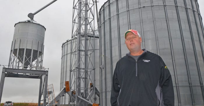 Scott Vyhnalek stands in front of his grain storage site near Friend. 