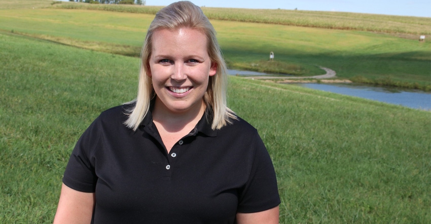closeup of Emily Doyle, a precision ag specialist, with field  and pond in the background