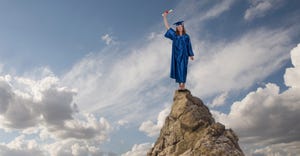 graduate standing on mountain top