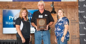 Holly Spangler presents Kenneth Hartman Jr. and wife Anita with the Master Farmer award