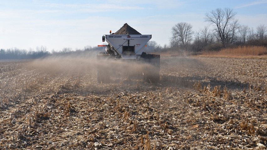 A tractor spreading variable-rate lime on a cornstalk field