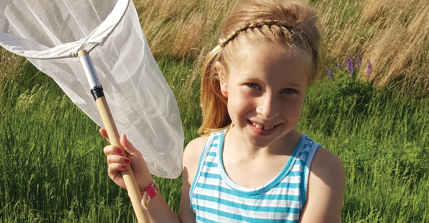 little girl holding bug net