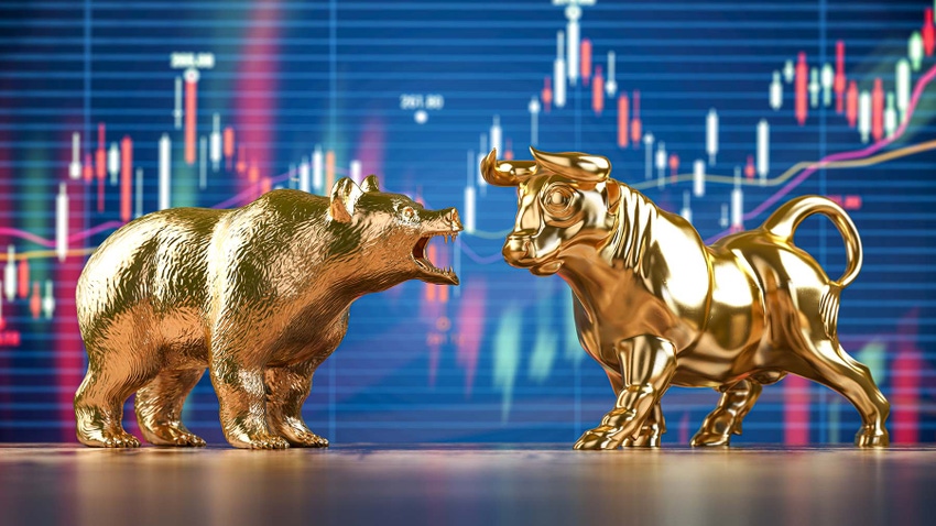 Gold bull and bear in front of market charts
