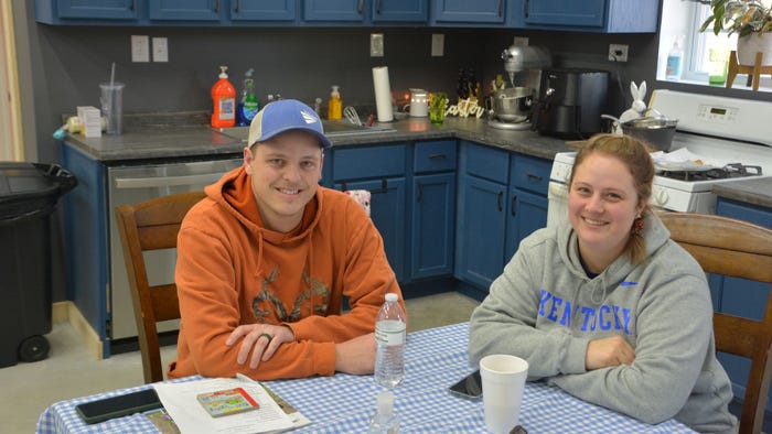Nathan and Aubrey Bush sit at a table in the kitchen of their farm shop