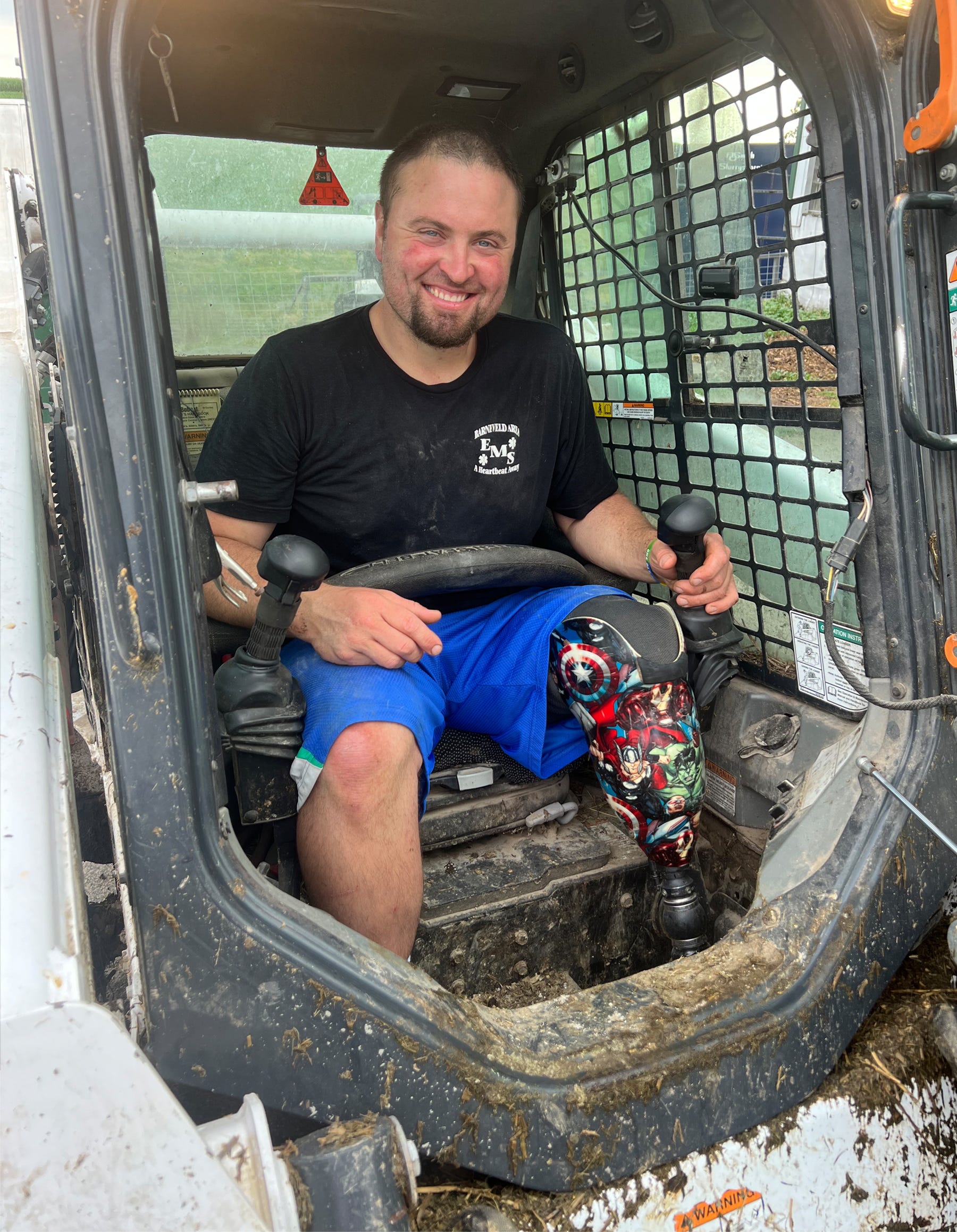 Kyle Thompson sits in his skid steer