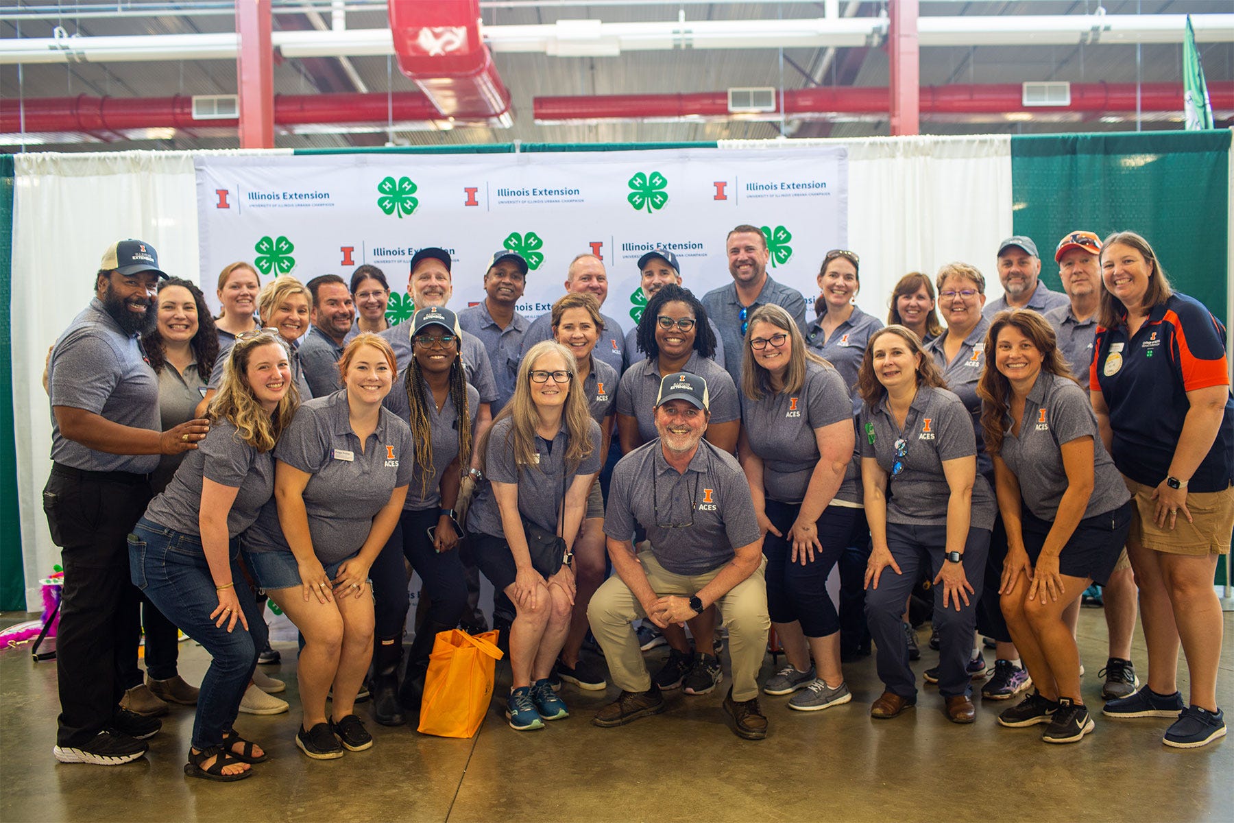 group of people wearing University of Illinois ACES shirts pose for a photo