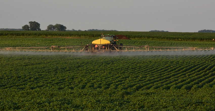 sprayer driving through field