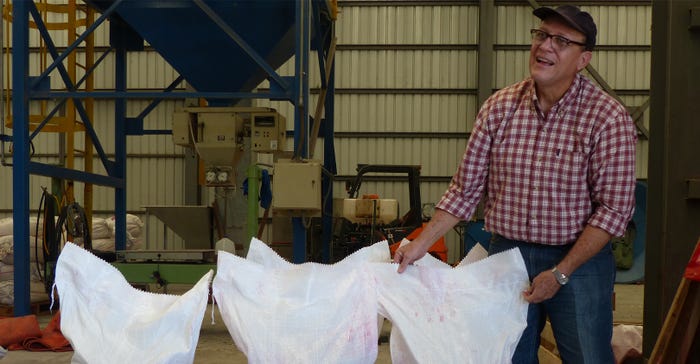 : Self-Help Nicaragua Country Director Jorge Campos inspects the five, 100-pound sacks of bio-fortified beans purchased by Se