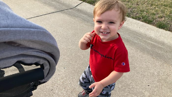 2-year-old boy in red shirt grinning 2-year-old boy in red shirt grinning