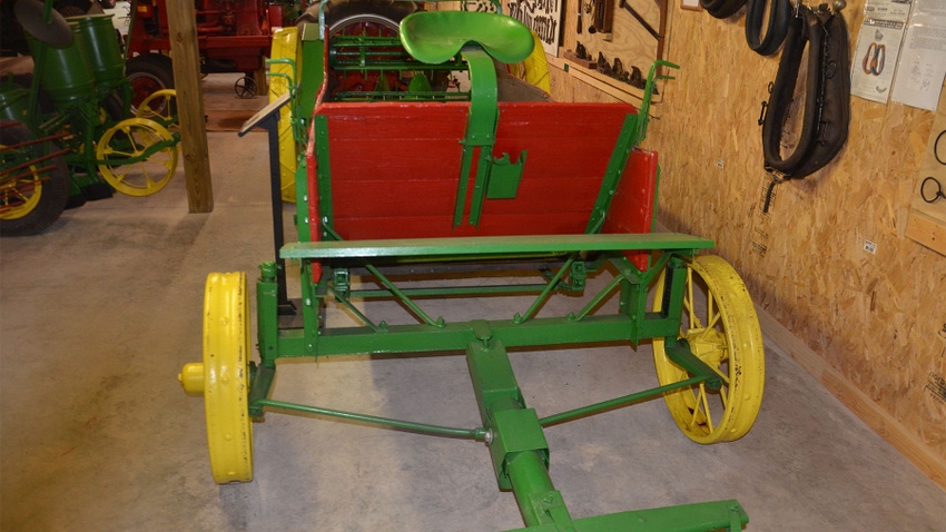 A vintage manure spreader in a museum