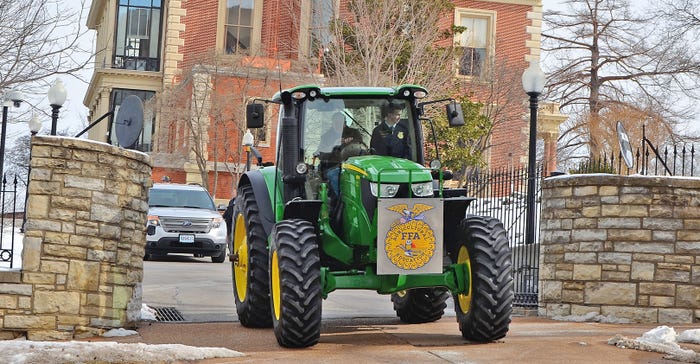 Missouri Gov. Mike Parson, Missouri State FFA President Paxton Dahmer on tractor