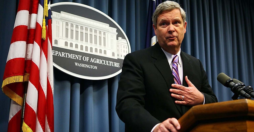 Tom Vilsack speaking at podium at USDA.