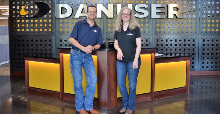 Siblings Glenn and Janea Danuser stand at the entrance to the Danuser Machine Company headquarters 