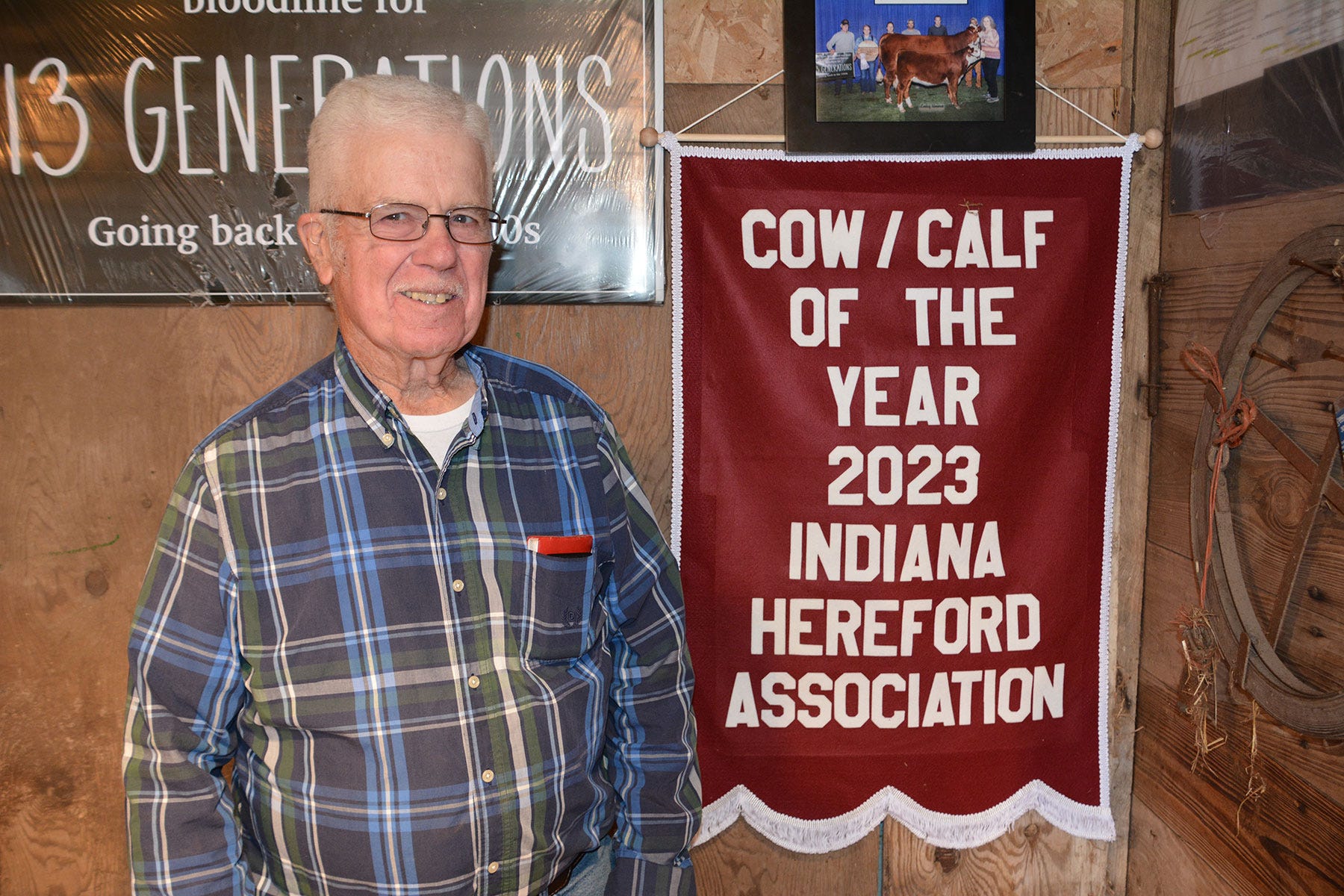 Ted Hunt poses with his 2023 Cow/calf of the year banner from the Indiana State Fair