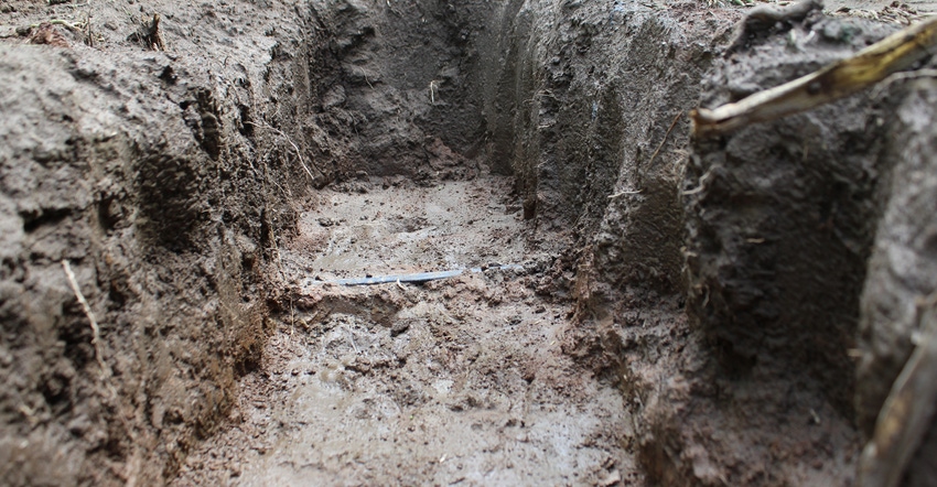 a ditch in dirt with tape in it a ditch in dirt with tape in it