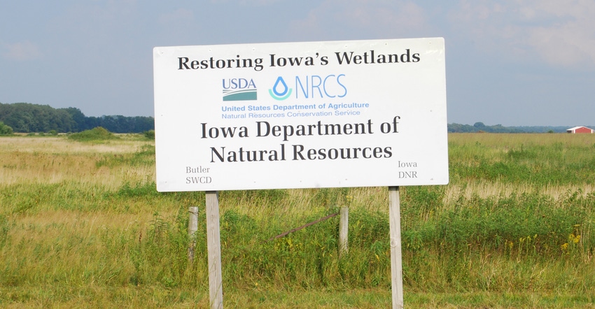 restoring iowas wetlands sign in field