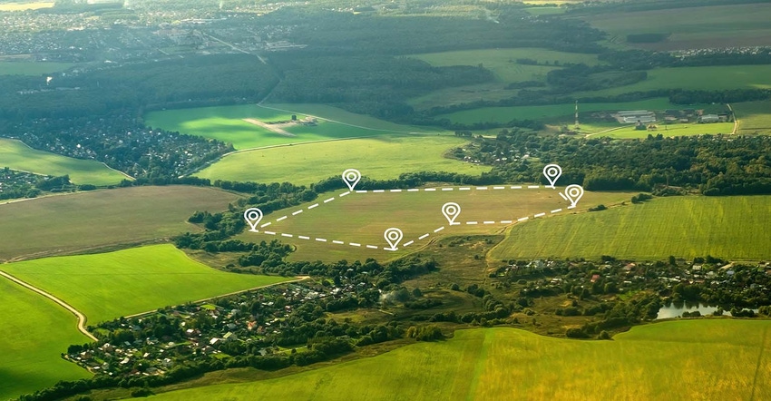 Aerial view of green field, position point and boundary line