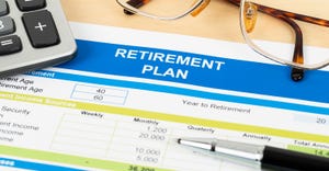 retirement plan paperwork, calculator, eyeglasses and pen